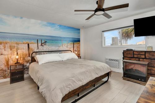 a bedroom with a bed and a view of the beach at Blue Mist Motel - Room # 11 in Daytona Beach