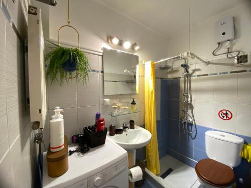 a bathroom with a sink and a toilet and a shower at Penny's luxury city apartment in Thessaloniki