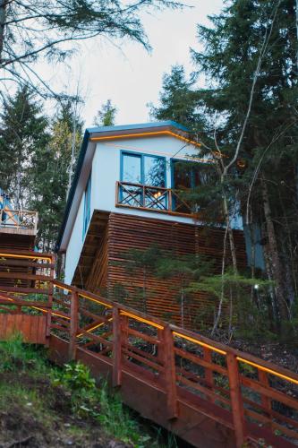a house in the woods with a wooden fence at Montana Suite Bungalows in Trabzon