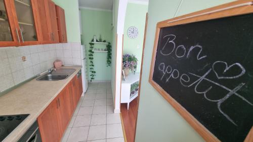 a kitchen with a chalkboard with the words burn yourself at Apartment with direct Sea View, Free Parking and close to Beaches and Promenade in Lovran