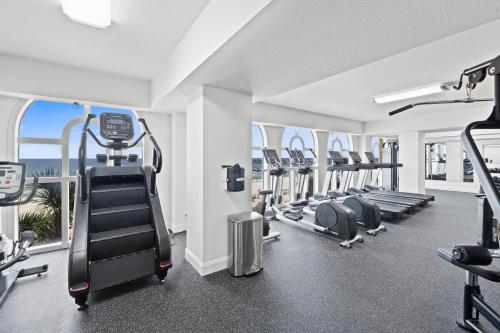 a gym with treadmills and ellipticals in a building at Calypso Beach Resort in Panama City Beach