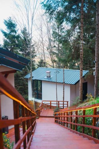 a house with a wooden fence and a walkway at Montana Suite Bungalows in Trabzon