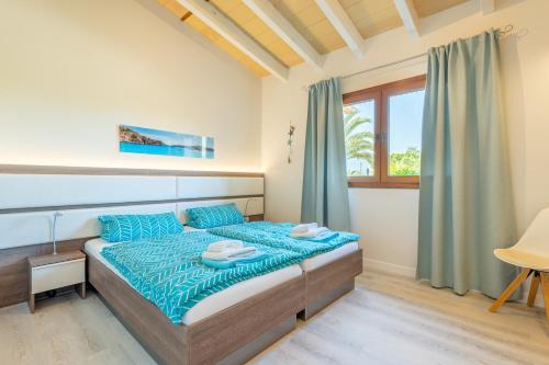 a bedroom with a bed and a window at Villa Sun Club Home in Llucmajor