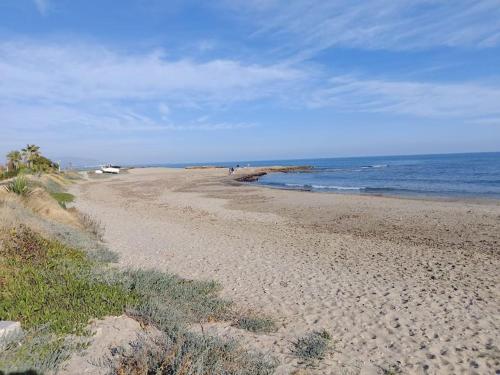 a sandy beach with the ocean in the background at Torre la Sal - Encanto natural 2 in Cabanes
