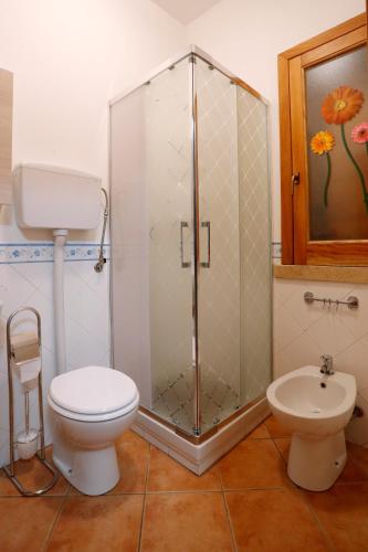 a bathroom with a shower and a toilet and a sink at Rosa Di Makari in Macari