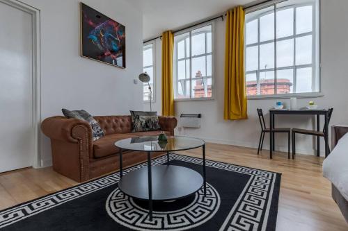 a living room with a couch and a table at Pass the Keys Spacious Flat in Bradford in Birmingham