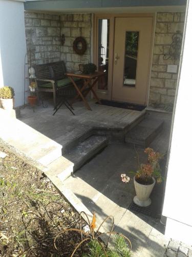 a front porch with a table and a door at Ferienhaus Meixner in Riedenburg