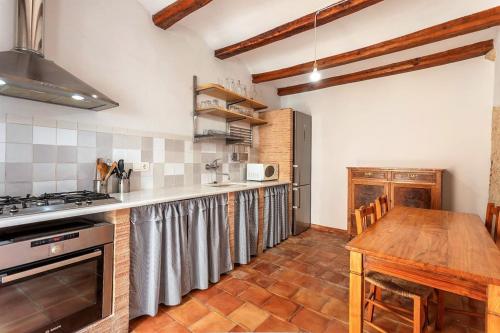 una cocina con encimera y mesa. en Casa con vistas a Mariola, en Bocairent