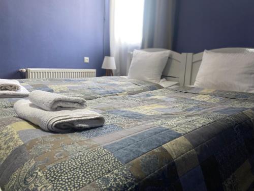 a bed with towels and pillows on top of it at Hillside Guesthouse in Borjomi