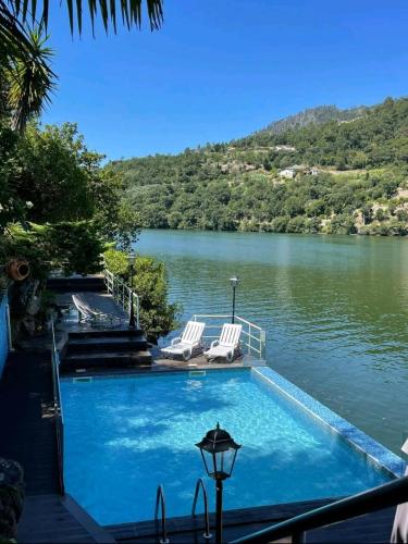a swimming pool with a view of a lake at Quinta de São Francisco in Cinfães