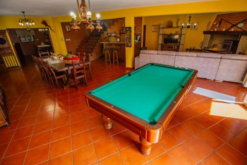 a living room with a pool table in the middle at Quinta de São Francisco in Cinfães