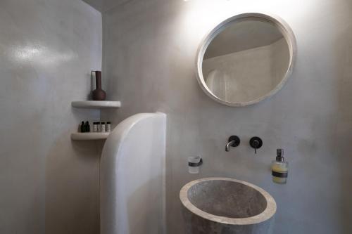 a bathroom with a sink and a mirror at The Sunset Windmill in Oia