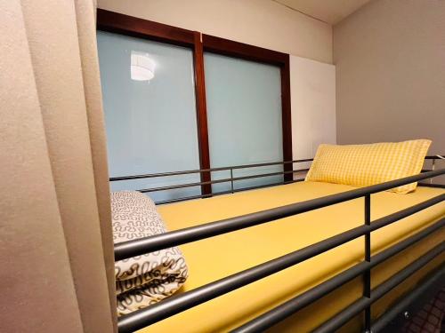 a balcony with a bed and a window at 綠色的日子 in Nantou City