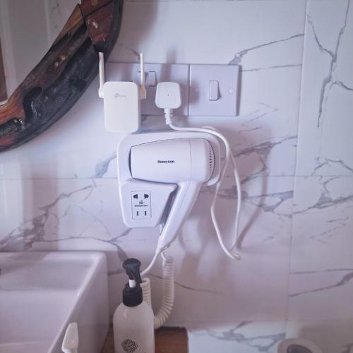 a bathroom with a soap dispenser and a sink at TIANDE Boutique Hotel in Pwani Mchangani
