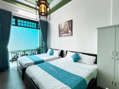Ένα ή περισσότερα κρεβάτια σε δωμάτιο στο Plumeria Homestay