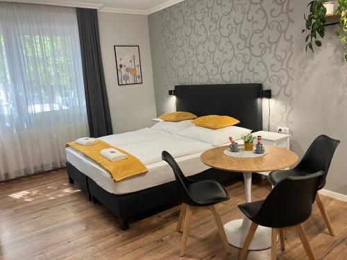 a bedroom with a bed and a table and chairs at ILLA Apartments in Eger