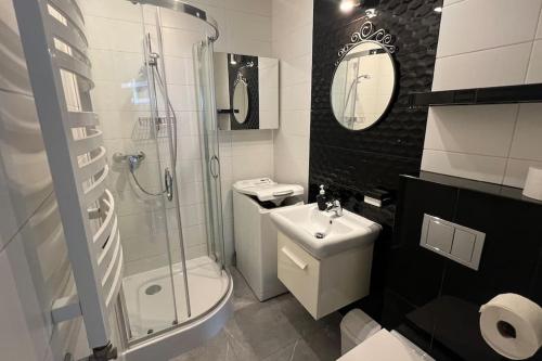 a bathroom with a toilet sink and a shower at Attic close to the beach and city center in Kołobrzeg