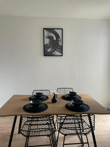 a wooden table with two chairs and a dining room at House Next to the Station in Watford