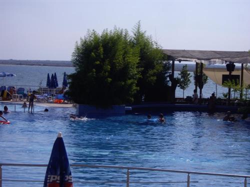 a swimming pool with people in the water at Relaks w Marina Cape 88 in Aheloy