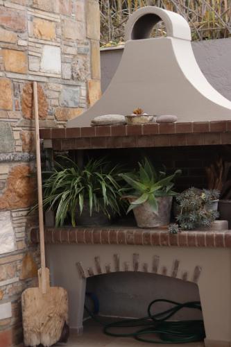 a fireplace with plants on top of it at OSTRIA BOUTIQUE HOME in Kalymnos