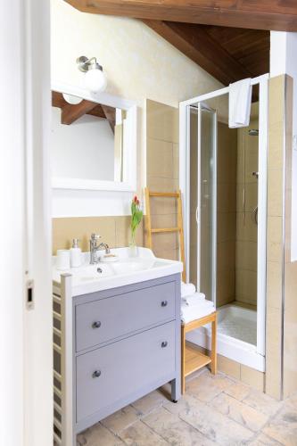 a bathroom with a white sink and a mirror at B&B Casa Fanny Riviera Del Conero in Loreto