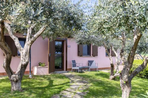 a pink house with trees in front of it at B&B Casa Fanny Riviera Del Conero in Loreto