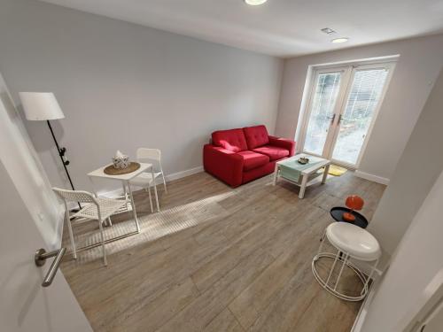 a living room with a red couch and a table at Slieve Apartment Suites in Birmingham