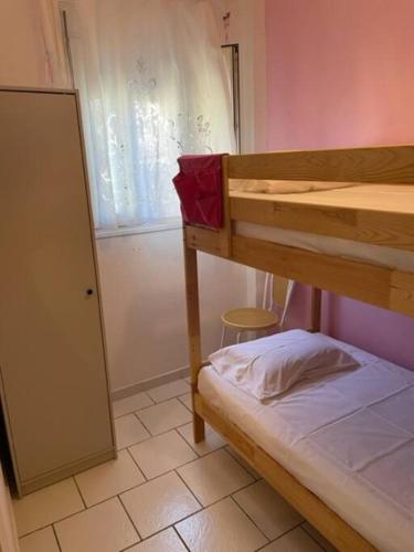 a small room with a bunk bed and a window at Lefki's House in Agiokampos