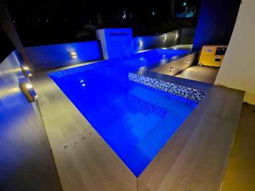 a swimming pool at night with blue lighting at Staycation At Sandari Batulao Overlooking Spot in Tagaytay