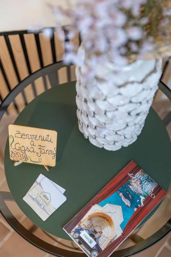 a green table with a vase on top of it at B&B Casa Fanny Riviera Del Conero in Loreto