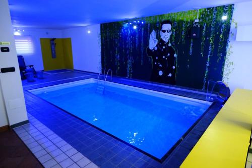 a swimming pool with a painting on the wall at Casa FedericaPet con piscina interna privata e riscaldata in Pagliare
