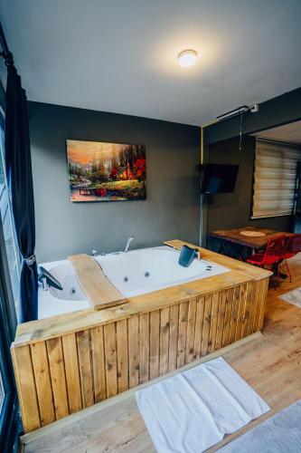 a large wooden tub in a room with a table at Montana Suite Bungalows in Trabzon