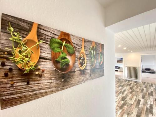 a wall with four wooden spoons on it at Worker Place Isselburg in Isselburg
