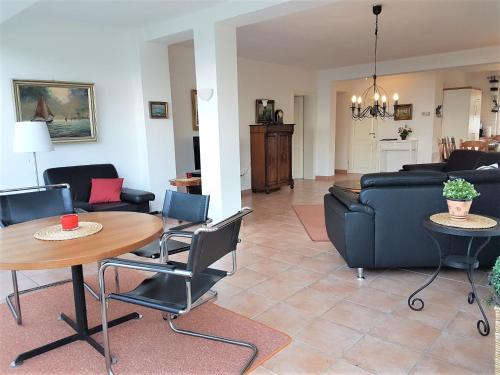 ein Wohnzimmer mit einem Tisch und einem Sofa in der Unterkunft Haus Meeresblick EG An der Rennweide 18, 100qm in Dangast