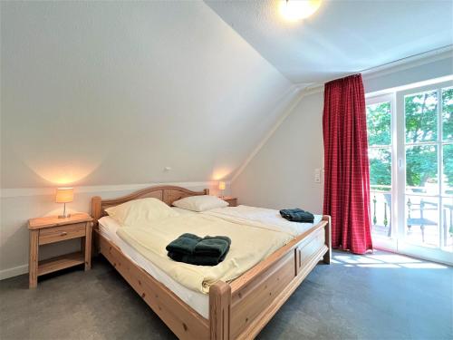 a bedroom with a bed and a large window at Apartmenthaus am Nordseestrand Whg 7, An der Rennweide 1B, 70qm in Dangast