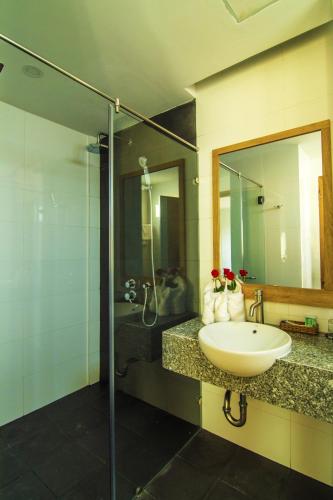 a bathroom with a sink and a shower at Sailing Hotel Phú Quốc in Phú Quốc