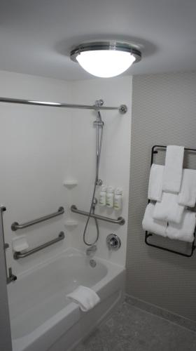 a bathroom with a bath tub and towels at Hawthorn Extended Stay by Wyndham Knoxville in Knoxville