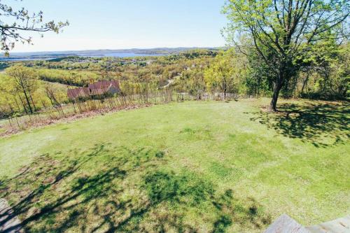 an open field with a tree in the middle at Hummingbird Hideaway in Branson