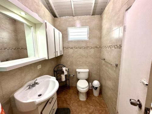 uma pequena casa de banho com lavatório e WC em Tropical Retreat Apt steps away from Combate Beach em Boquerón