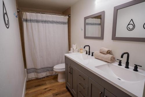 a bathroom with a white sink and a toilet at Drifting Snow Cabin - Pinetop, AZ in Indian Pine