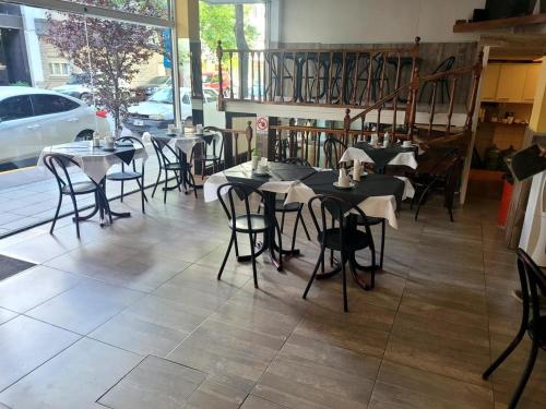 a group of tables and chairs in a restaurant at Hotel Canciller in Mar del Plata