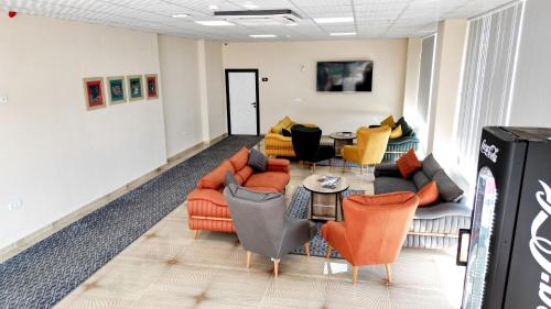a living room with couches and chairs and a table at Vizyon Otel Darıca in Darıca