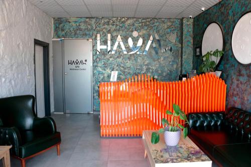 a waiting room with orange chairs and a lobby at Vizyon Otel Darıca in Darıca