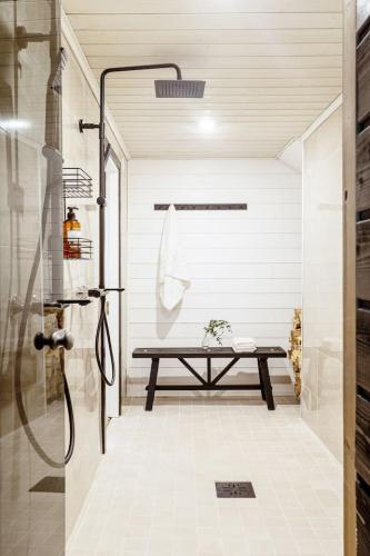 a bathroom with a shower and a picnic table at Stay North - Villa Kalksved in Sipoo