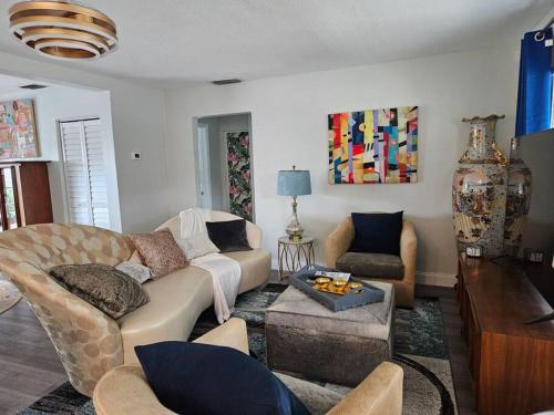 a living room with a couch and a table at 3 bedroom Casa Azul in Historic Northwood Hills in West Palm Beach