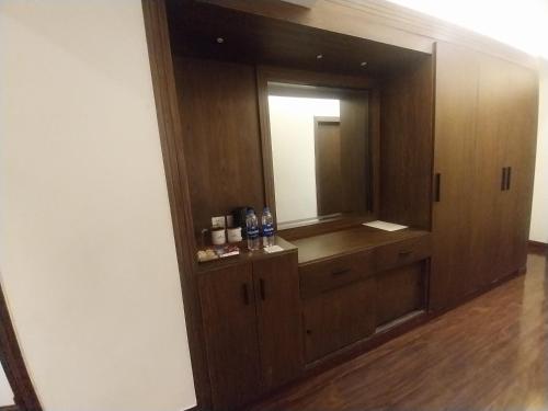 a bathroom with a mirror and a wooden cabinet at Hotel MERIDIAN in Kary