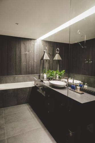 a bathroom with a sink and a mirror at Frost Boutique Hotel in Pärnu