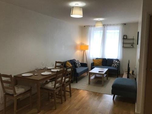 a dining room with a table and a living room at May Disc - Long Stay - Contractors in Bristol