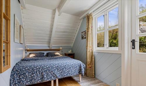 a bedroom with a bed and a window at Salteriet in Vinnes