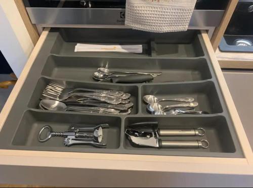 a tray of utensils in a drawer in a kitchen at Apartment Viesturdārz in Rīga